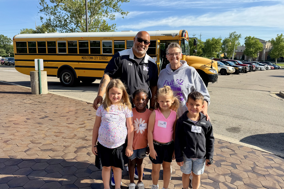 photo of superintendent with a group of students